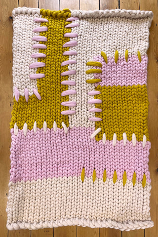 Handmade cream, pink and mustard colour block super chunky knitted blanket with thick patchwork stitching